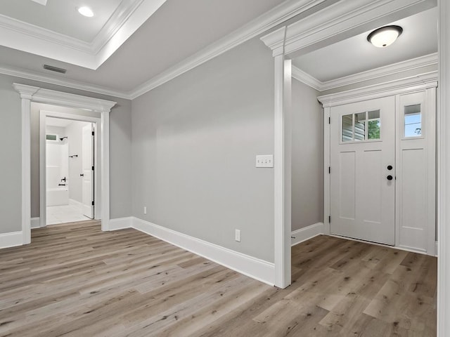 entryway with light wood-type flooring and crown molding