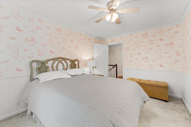 bedroom with light colored carpet, ceiling fan, and ornamental molding