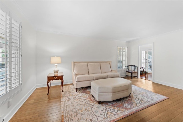 living room featuring hardwood / wood-style floors and ornamental molding