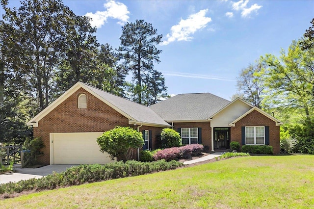 single story home featuring brick siding, concrete driveway, and a front yard
