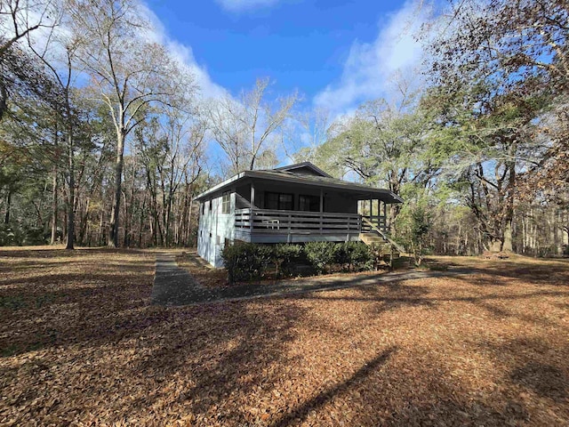 view of side of property featuring covered porch