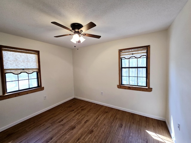 unfurnished room with plenty of natural light, baseboards, and dark wood-style flooring