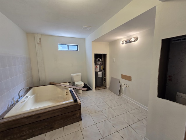 full bathroom featuring tile patterned flooring, toilet, a bath, and electric water heater