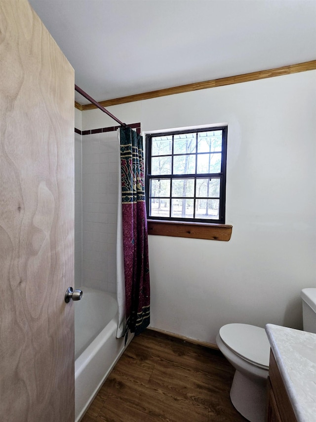 bathroom featuring shower / bath combo with shower curtain, toilet, ornamental molding, wood finished floors, and vanity