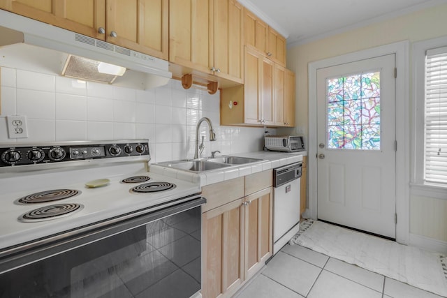 kitchen featuring white dishwasher, a sink, light brown cabinets, under cabinet range hood, and range with electric stovetop