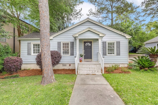 bungalow-style home featuring crawl space and a front yard