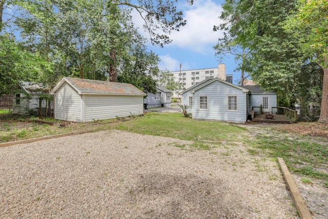 view of yard with a wooden deck and an outdoor structure