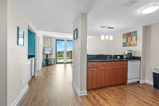 300 S Duval St Unit 503, Tallahassee, FL 32301 - kitchen featuring white dishwasher, dark wood-type flooring, a textured ceiling, a sink, and dark countertops