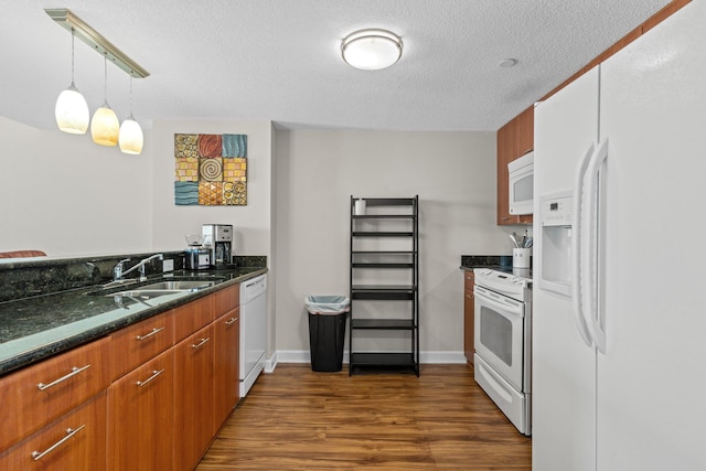 300 S Duval St Unit 503, Tallahassee, FL 32301 - kitchen featuring white appliances, a sink, dark wood-type flooring, a textured ceiling, and dark stone countertops