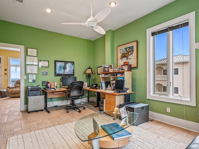 home office featuring a wealth of natural light and ceiling fan