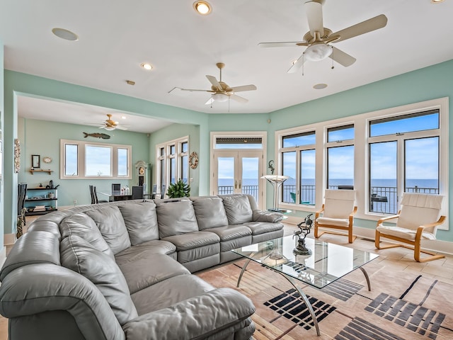 living room with a water view and french doors