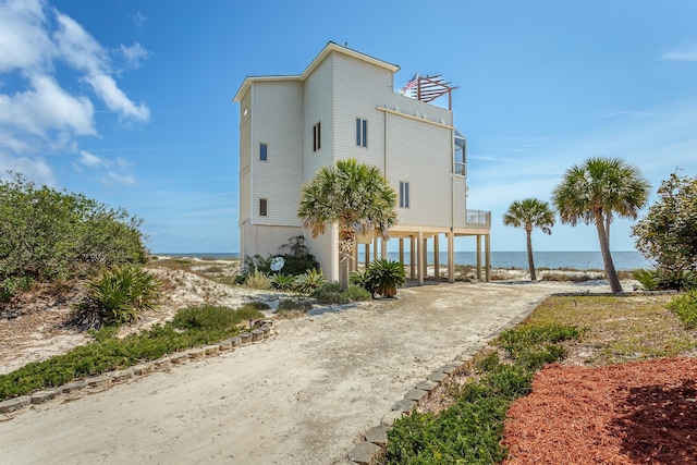 view of side of home featuring a water view and a carport