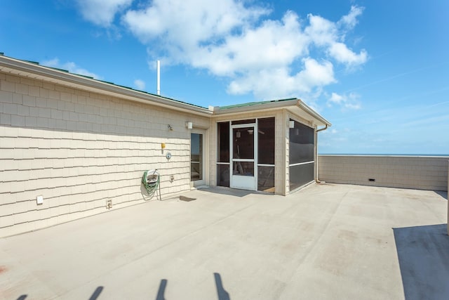 view of patio / terrace featuring a sunroom