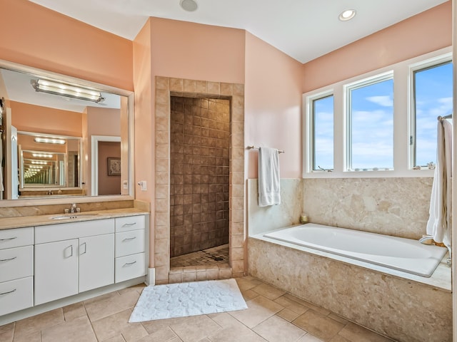 bathroom with tile patterned flooring, vanity, and separate shower and tub