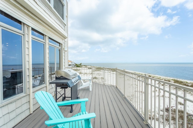 balcony featuring grilling area, a water view, and a view of the beach