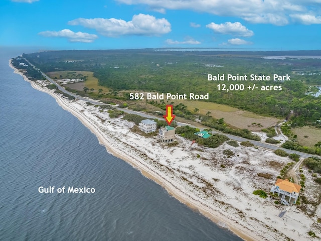 drone / aerial view featuring a water view and a beach view