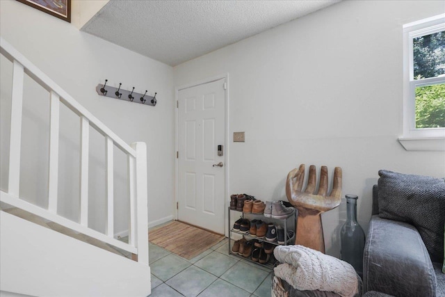 1520 Pullen Rd Unit 6, Tallahassee, FL 32303 - tiled entryway with stairway and a textured ceiling