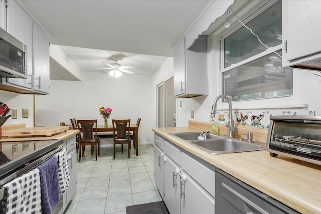 1520 Pullen Rd Unit 6, Tallahassee, FL 32303 - kitchen featuring stainless steel appliances, a sink, light countertops, light tile patterned floors, and a ceiling fan