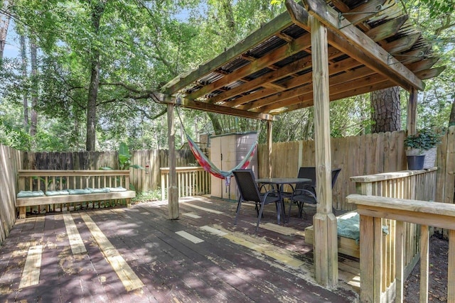 1520 Pullen Rd Unit 6, Tallahassee, FL 32303 - wooden deck featuring a storage unit, a fenced backyard, an outbuilding, and outdoor dining area
