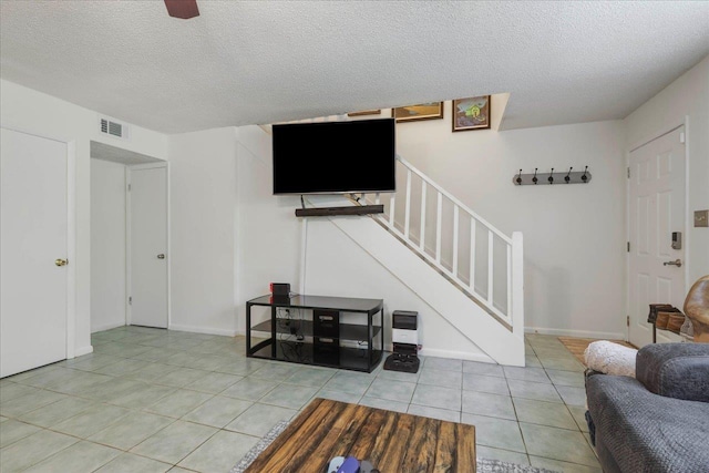 1520 Pullen Rd Unit 6, Tallahassee, FL 32303 - living room featuring stairway, tile patterned flooring, and a textured ceiling