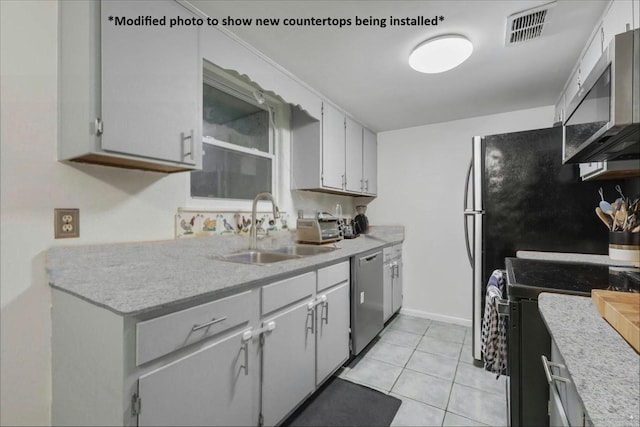 1520 Pullen Rd Unit 6, Tallahassee, FL 32303 - kitchen featuring appliances with stainless steel finishes, a sink, light countertops, and light tile patterned flooring