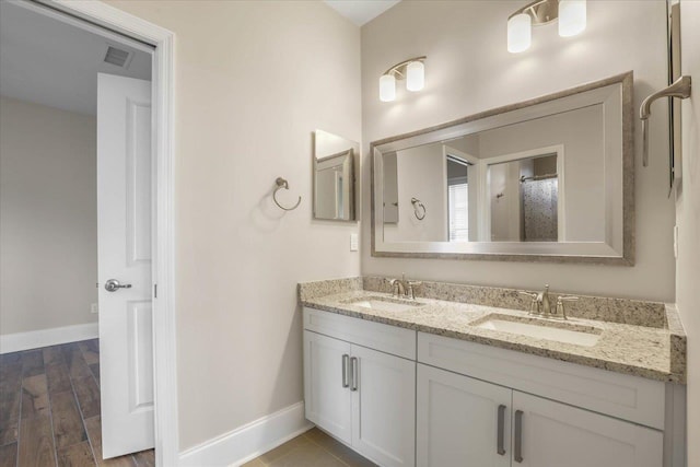 bathroom with vanity and hardwood / wood-style flooring