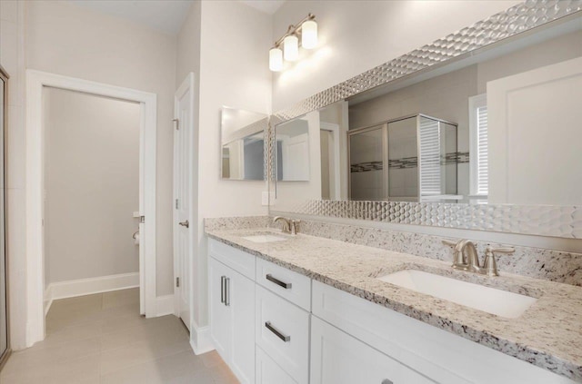 bathroom with tile patterned floors, vanity, and an enclosed shower