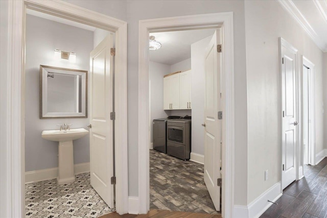 hall featuring crown molding, washer and clothes dryer, and sink