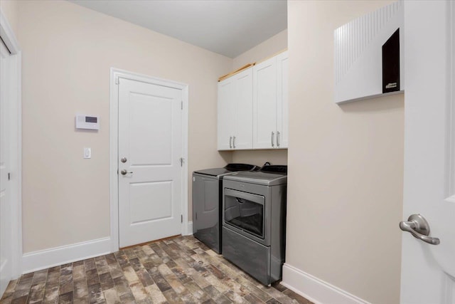 washroom with hardwood / wood-style flooring, cabinets, and independent washer and dryer