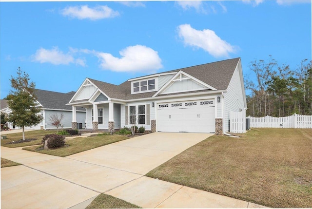 craftsman house featuring a garage and a front lawn