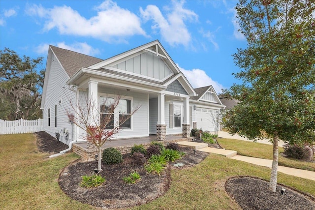 craftsman-style house with a front yard and a garage