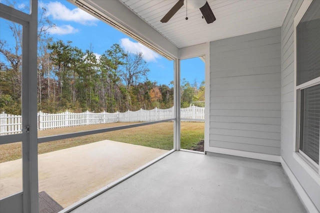 unfurnished sunroom featuring ceiling fan