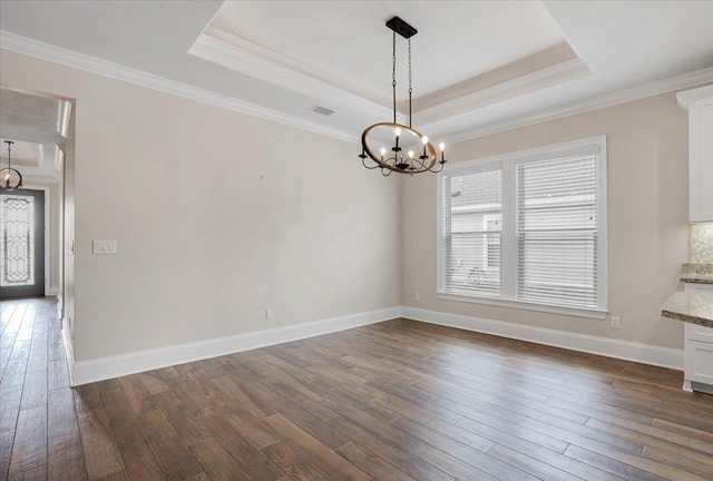 unfurnished dining area featuring a raised ceiling, dark hardwood / wood-style flooring, and ornamental molding