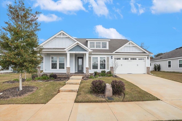 craftsman inspired home with a garage and a front lawn