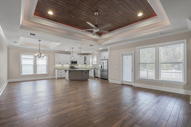 unfurnished living room featuring wood ceiling, ceiling fan with notable chandelier, a raised ceiling, dark wood-type flooring, and crown molding