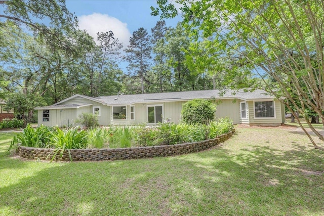 rear view of house featuring a yard