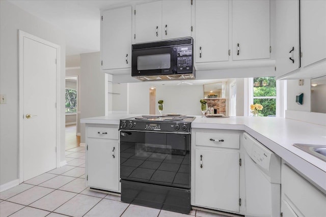 kitchen with light countertops, white cabinets, black appliances, and a healthy amount of sunlight