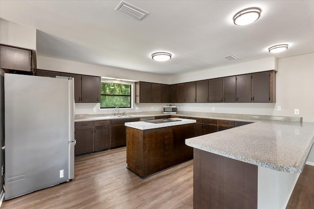 16552 198th Trace, Trace, FL 32071 - kitchen featuring stainless steel appliances, dark brown cabinets, light countertops, and a peninsula