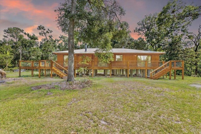 16552 198th Trace, Trace, FL 32071 - back of property at dusk featuring stairs, a wooden deck, and a yard