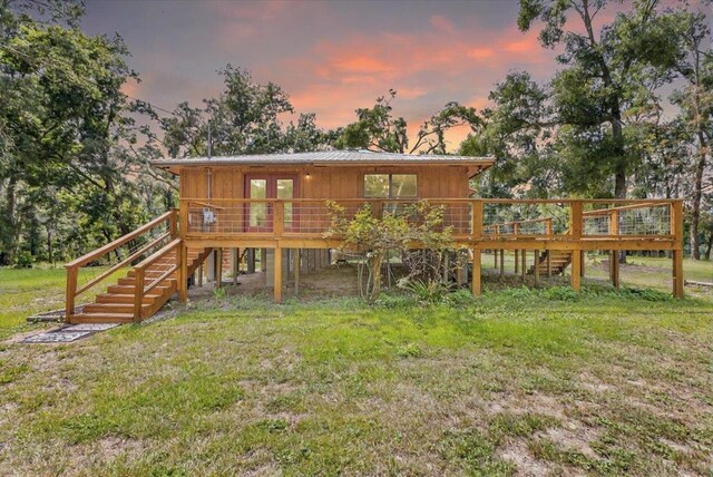 16552 198th Trace, Trace, FL 32071 - back of property at dusk with stairway, a wooden deck, and a yard