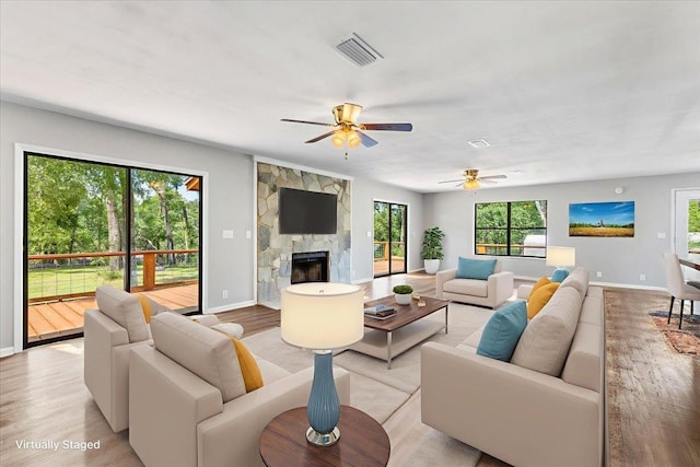 16552 198th Trace, Trace, FL 32071 - living area with a fireplace, light wood-style flooring, and a ceiling fan