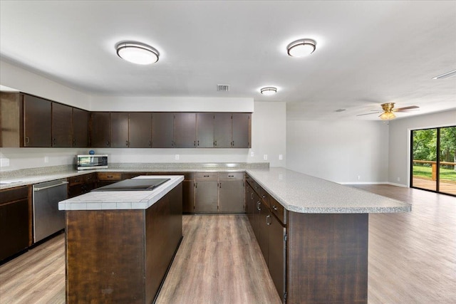 16552 198th Trace, Trace, FL 32071 - kitchen with stainless steel appliances, a peninsula, light wood-style floors, and dark brown cabinets