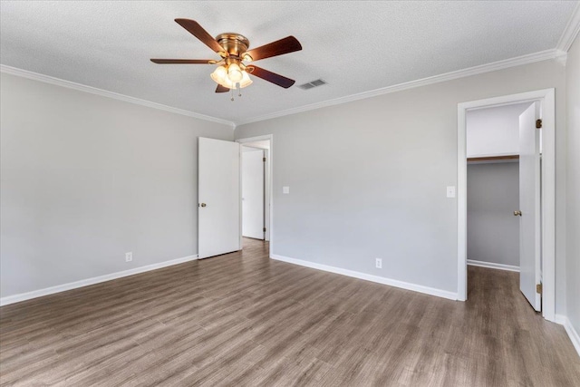 16552 198th Trace, Trace, FL 32071 - unfurnished bedroom with wood finished floors, a spacious closet, ornamental molding, ceiling fan, and a textured ceiling