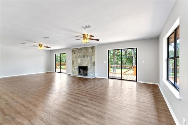 16552 198th Trace, Trace, FL 32071 - unfurnished living room featuring wood finished floors, a ceiling fan, and a large fireplace