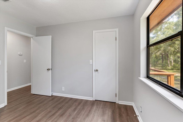 16552 198th Trace, Trace, FL 32071 - unfurnished bedroom featuring wood finished floors and multiple windows