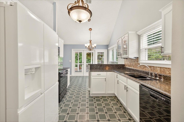 2032 Ascot Way, Tallahassee, FL 32312 - kitchen with black appliances, dark countertops, white cabinets, french doors, and a peninsula