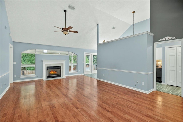 2032 Ascot Way, Tallahassee, FL 32312 - unfurnished living room featuring high vaulted ceiling, a ceiling fan, wood finished floors, and a fireplace with flush hearth