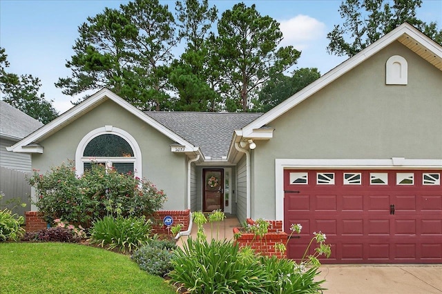 2032 Ascot Way, Tallahassee, FL 32312 - view of front of property with stucco siding, roof with shingles, and an attached garage