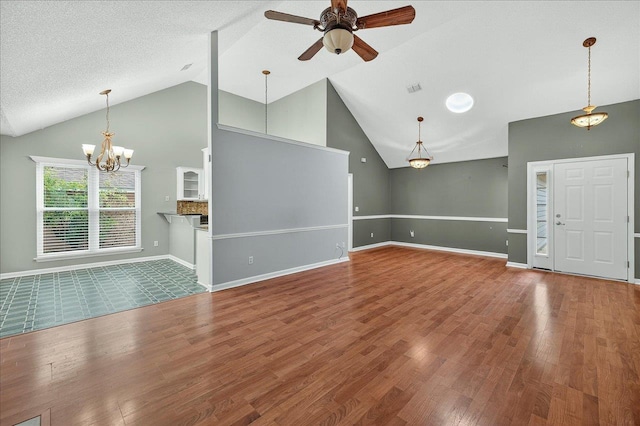 2032 Ascot Way, Tallahassee, FL 32312 - unfurnished living room with a ceiling fan, wood finished floors, a chandelier, and high vaulted ceiling
