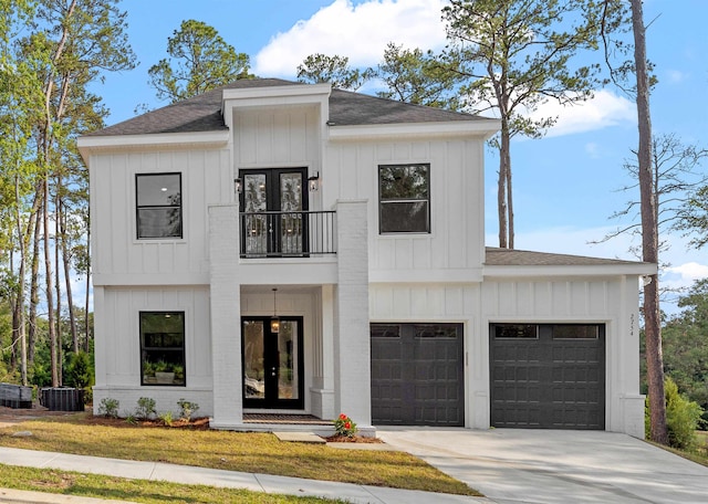 modern farmhouse featuring a front lawn and a garage